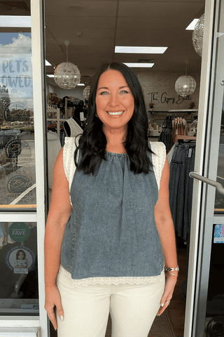 Denim sleeveless top with lace sleeve and hem, perfect for stylish casual wear. Shop chic tops online.
