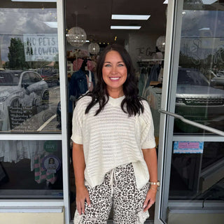 Alt text: "Elegant Ivory Crochet Top with Cuff Sleeves and Side Slit, Perfect for Layering, Boho Style.