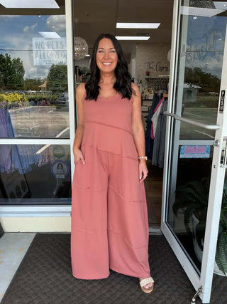 Model wearing NoaBoa Keyhole Back Wide Leg Jumpsuit in beige, featuring raw edges, available in two colors.