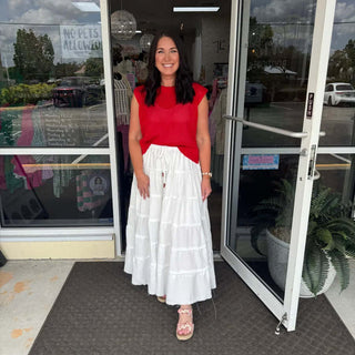 White tiered drawstring waist maxi skirt on mannequin, showcasing lightweight fabric and elegant flowy design.