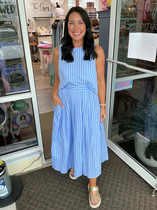 Woman wearing Shades of Blue Stripe Skirt Set by Entro, featuring a chic off-the-shoulder crop top and matching flowy skirt.