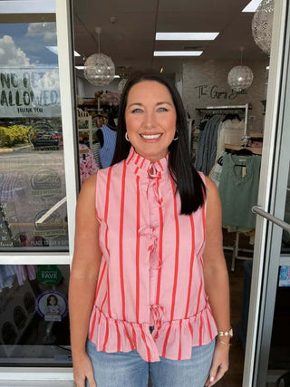 Women’s sleeveless peplum top with pink and coral stripes, featuring a stylish front tie, perfect for a chic summer look.