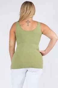 Model wearing OLIVE Buttery Soft Reversible Seamless Tank, showcasing its sleek design and comfortable fit in a neutral setting.
