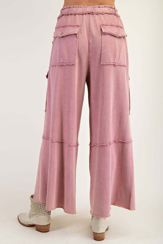 A model wearing Washed Wide Leg French Terry Cargo Pants in olive green; available in 4 colors by Easel.