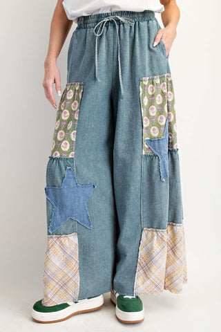 Washed denim patchwork wide-leg palazzo pants by Easel, showcasing a trendy bohemian style with a relaxed fit.