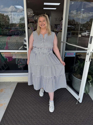 Curvy striped sleeveless midi dress with split neck available in two colors, perfect for stylish and versatile summer wear.