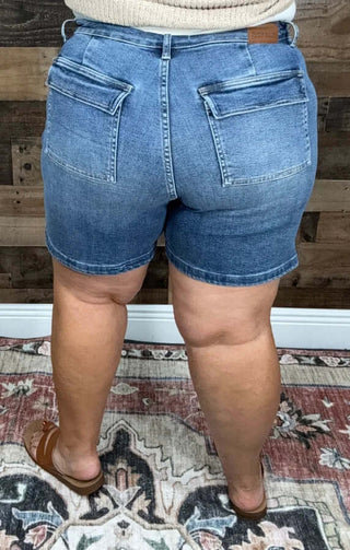 Judy Blue Dark Wash Utility Midi Shorts with side pockets, perfect for casual summer wear and versatile styling options.