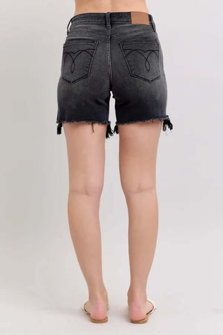Judy Blue Black Cut Off Two Button Shorts on white background, featuring a stylish frayed hem and double button detail.