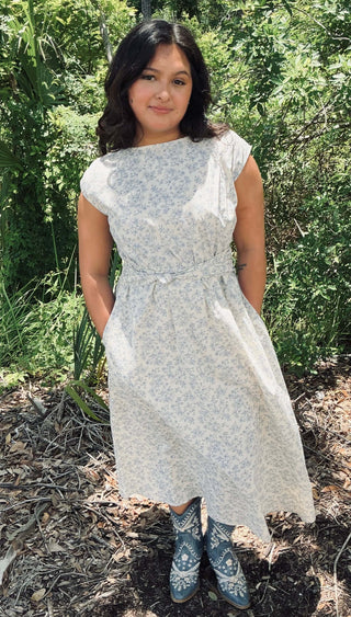 Ivory & Blue Boat Neck Sleeveless Floral Midi Dress with Pleats on a Mannequin, Elegant Spring-Summer Fashion.