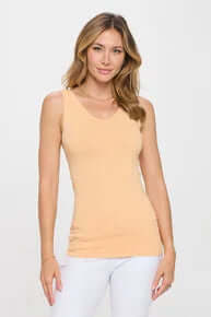 Alt text: "PEACH buttery soft reversible seamless tank, displayed on hanger against a neutral background.