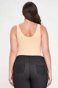 Alt text: "NUDE BODYSUIT - Buttery Soft Seamless Tank, shown flat with a sleek design and premium fabric texture.