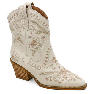 Ivory embroidered booties with chic tassels, stylish floral design, and elegant pointed toes for fashion-forward women.