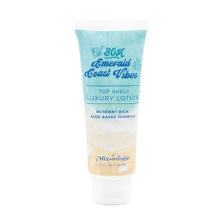 AMI Emerald Coast Mixologie Top Shelf Luxury Lotion in a sleek bottle with coastal theme, on a white background.