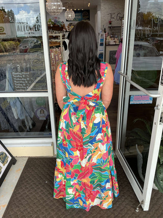 Red tropical print tiered maxi dress by Skies Are Blue, featuring a flattering V-neck and adjustable straps against a white background.