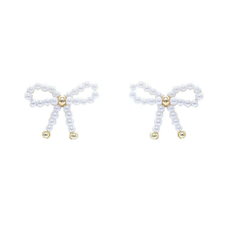 Elegant Pearl & Gold Bow Post Earrings with Coquette Style on Display Against a Soft Pastel Background