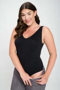 Sleek black bodysuit combining buttery soft texture with a seamless tank design for ultimate comfort and elegance.