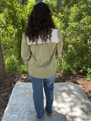 Olive green button-down top with a contrasting collar and a relaxed fit