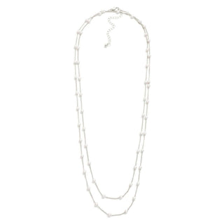 Silver long chain necklace featuring elegant pearl stations, perfect for adding a touch of sophistication to any outfit.
