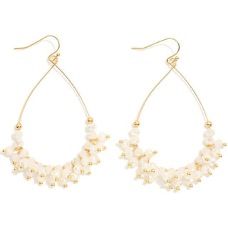 Elegant white and gold faceted bead teardrop earrings on display, enhancing any outfit with a touch of sophistication.