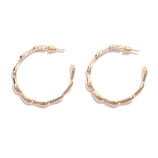 Elegant gold cinched hoop earrings with a clasp closure, perfect for adding a touch of sophistication to any outfit.