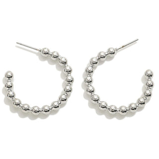 Silver Fixed Metal Bead Hoop Earrings elegantly displayed on a soft surface, highlighting sleek design and craftsmanship.