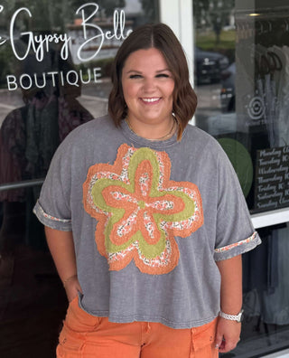Mineral washed blue short sleeve top with vibrant orange flower patch from Easel