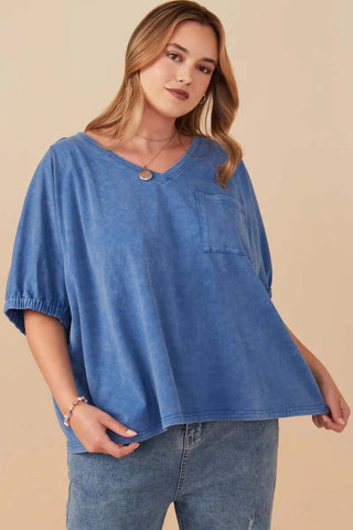 Model wearing denim blue mineral washed cap sleeve pocket top, chic casual fashion with a comfortable and stylish fit.
