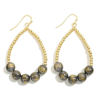Elegant teardrop earrings with gold beads and graphite stones, perfect for a chic and sophisticated look.