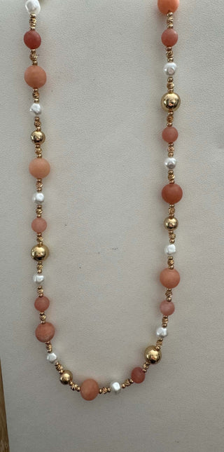 Elegant gold, pearl, and peach coral beaded necklace; perfect for adding a touch of luxury and style to any outfit.