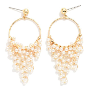 Elegant gold and pearl tassel hoop earrings with post drop design, perfect for adding a touch of sophistication to any outfit.