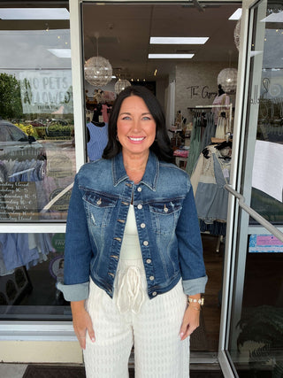 Judy Blue Distressed Classic Stretch Jacket with buttoned front, light wash, and vintage appeal, displayed on a wooden hanger.
