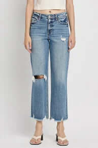 Alt text: "Lovervet LV1143 high-rise straight leg distressed med wash dad jeans on a mannequin with a pastel backdrop.