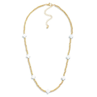 Elegant white dainty cross necklace with gold beads, perfect for adding a subtle touch of sophistication to any outfit.