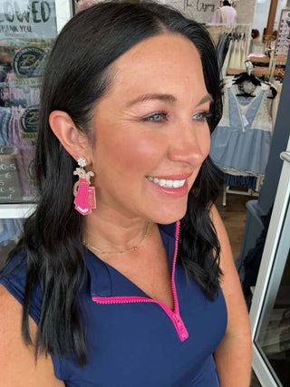 Stylish pink seed bead golf bag earrings with pearl accents for a chic, unique accessory.