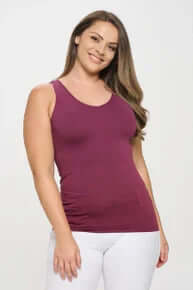 Model wearing PLUM Buttery Soft Reversible Seamless Tank showcasing its fit and versatility in a stylish pose.