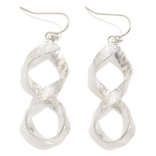 Close-up of Silver Textured Twisted Drop Earrings on a white background showcasing their elegant design and intricate detailing.