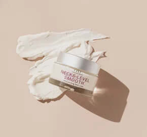 FHF Necks-Level Smooth Ultra-Smoothing Triple Effect Neck Cream in elegant jar with blooming white flowers.