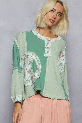 Mint green floral patch top with short sleeves and a relaxed fit