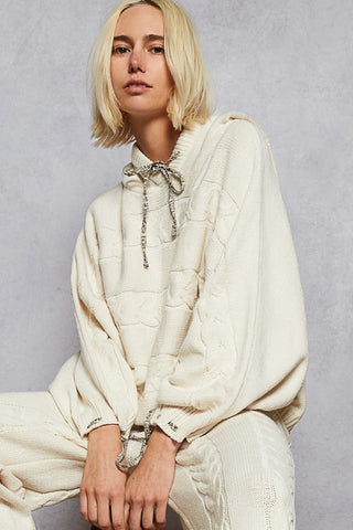 Soft cream chenille cable sweater top with a relaxed dolman silhouette and long sleeves
