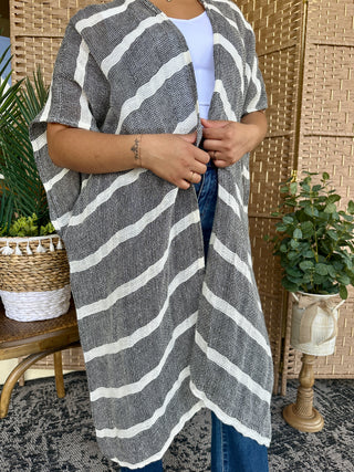 Charcoal and white striped short-sleeve kimono worn over white tee and blue jeans.

