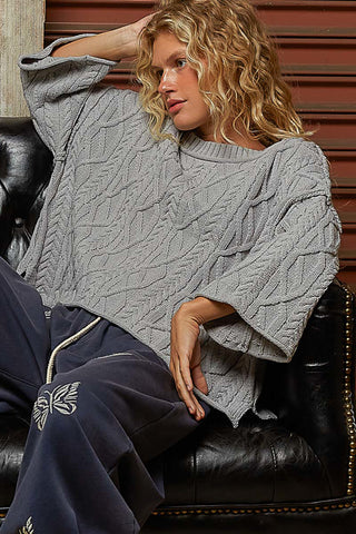Oversized round neck cable knit sweater in soft cream, featuring a cozy texture and relaxed fit