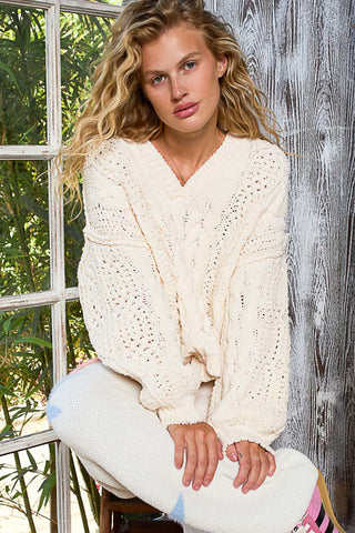 Oversized cable knit v-neck sweater in soft cream color