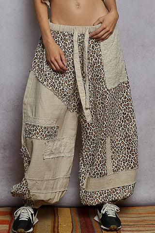 Almond-colored joggers with a stylish leopard print patchwork design