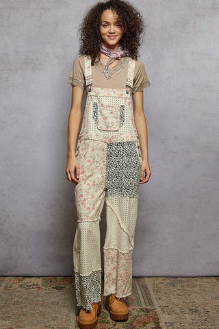 Cream twill overalls featuring a floral and animal print design, perfect for a stylish and playful look