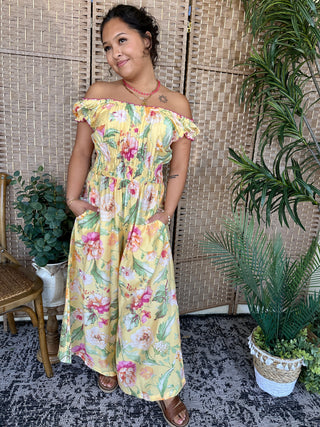 Yellow off-shoulder midi dress with colorful floral print, ruched waist, and short flutter sleeves.
