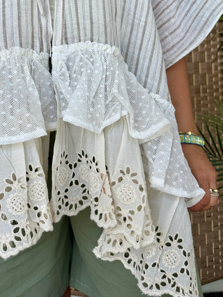 Gray striped kimono top with white lace ruffled hem and eyelet embroidered details.
