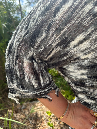 Charcoal and white striped short-sleeve top with textured slub fabric and star patch detail.
