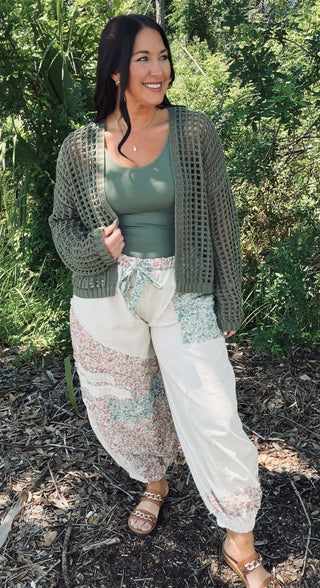 Female model wearing Doe & Rae Crochet Open Weave Cropped Cardigan, available in two colors, standing against a neutral background.
