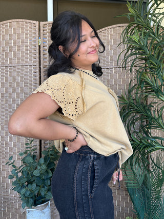 Cream oversized tee with eyelet lace flutter sleeves and textured terry fabric.

