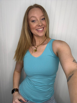 Seafoam reversible seamless tank with V-neckline on model, paired with necklace and watch.
